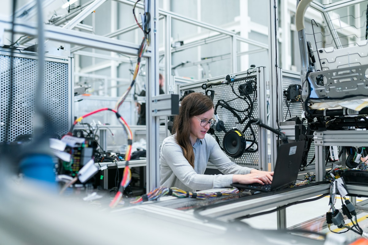 Factory worker monitoring industrial production equipment