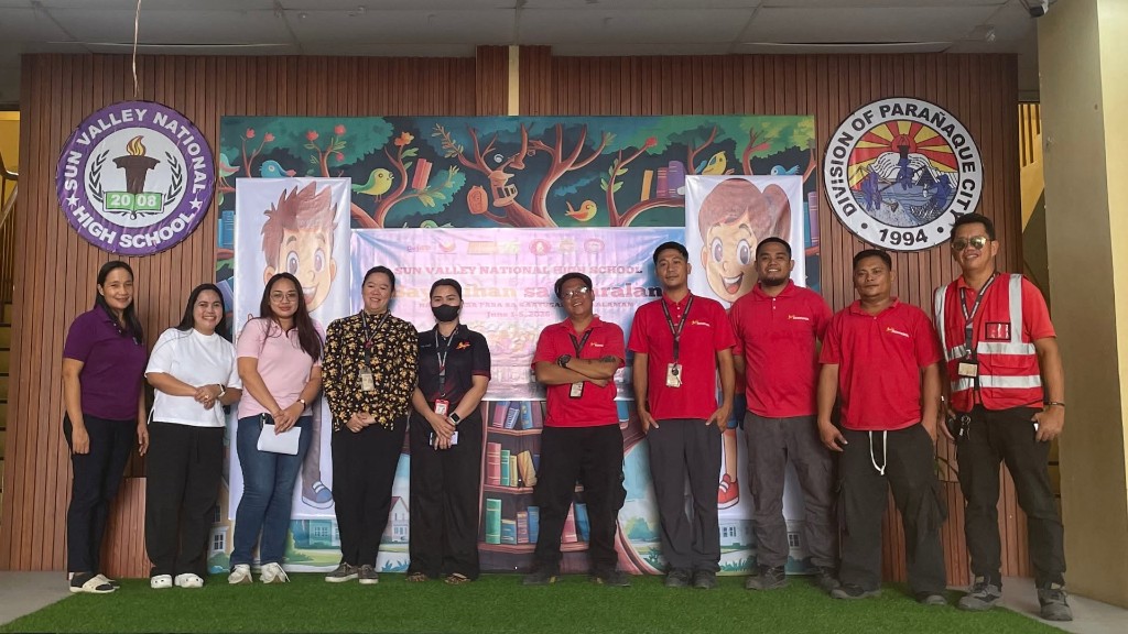 Nonpareil and Sun Valley National High School representatives on stage with Brigada Eskwela backdrop